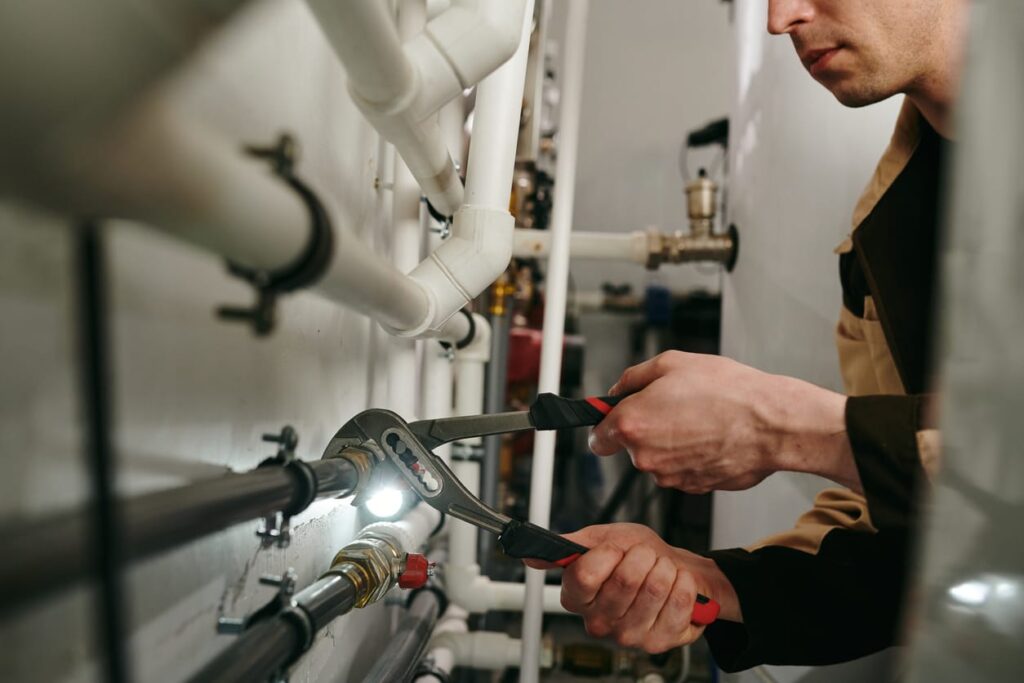 Plumbers maintaining commercial plumbing pipes in Lancaster