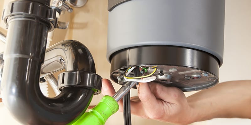Technician repairing the heating element of a water heater in Lancaster