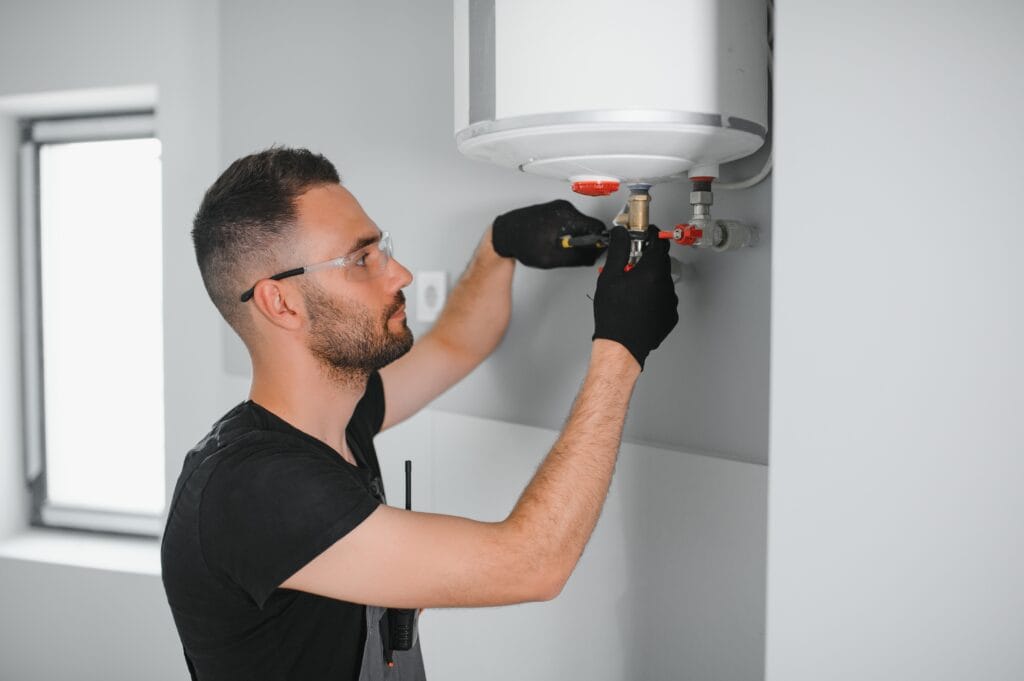 Technician performing water heater maintenance in Lancaster